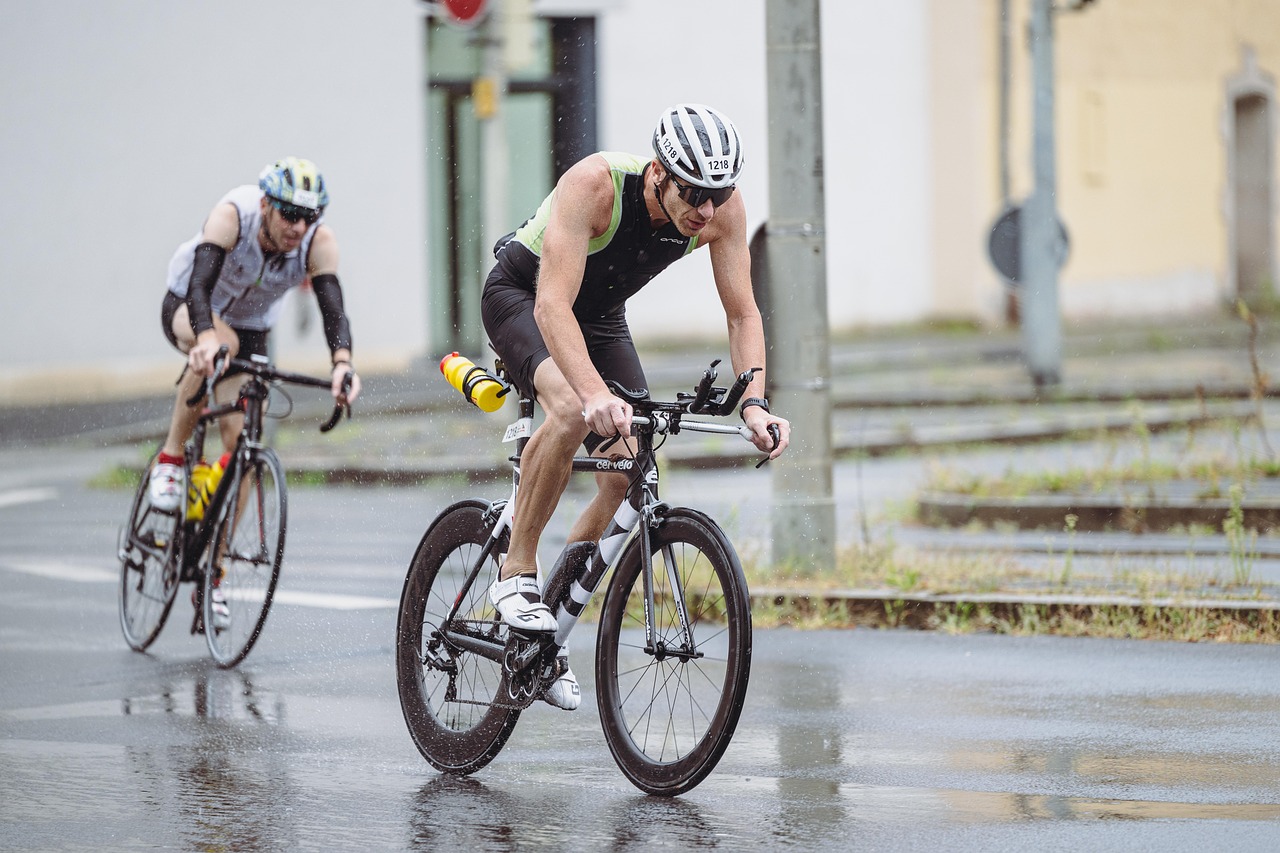 Cyclist smiling in the rain with proper gear after checking the forecast